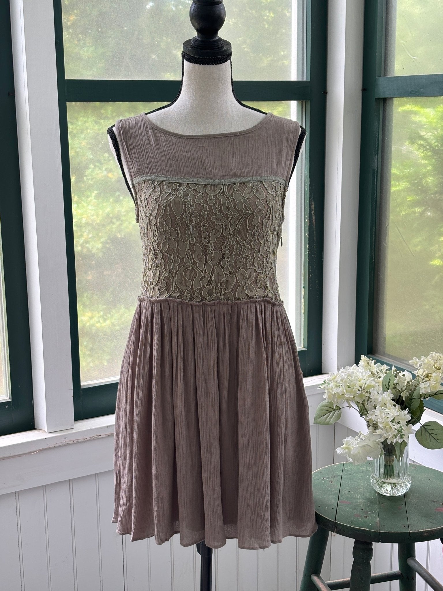 Hayden Los Angeles taupe crinkle drop waist dress on mannequin, sage green floral lace bodice panel and full gathered skirt, size Small NWT