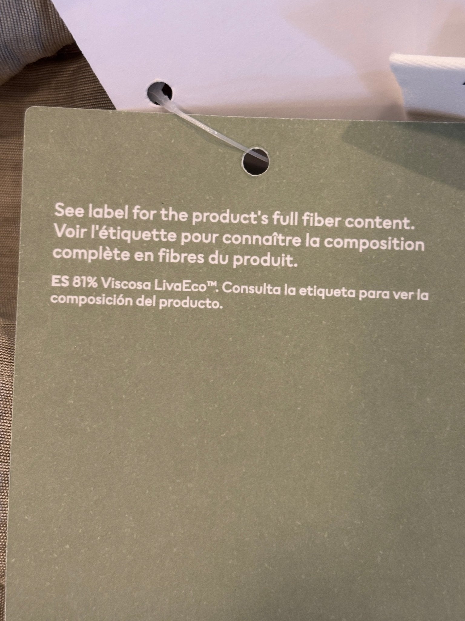 Hang tag showing 81% LivaEco Viscose fabric content, H&M Conscious collection