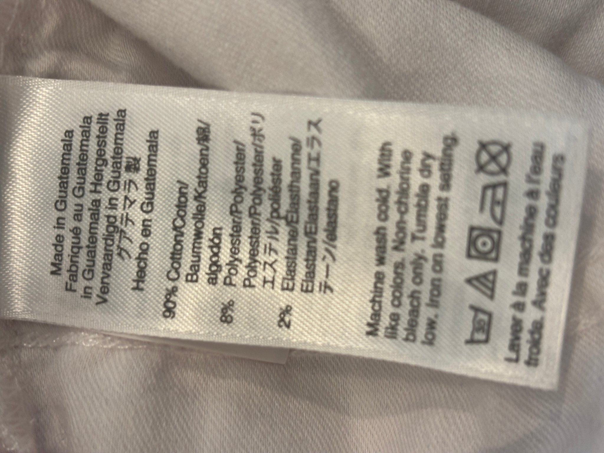 Care label showing 90% Cotton 8% Polyester 2% Elastane for J.Crew white curvy demi boot jeans, made in Guatemala