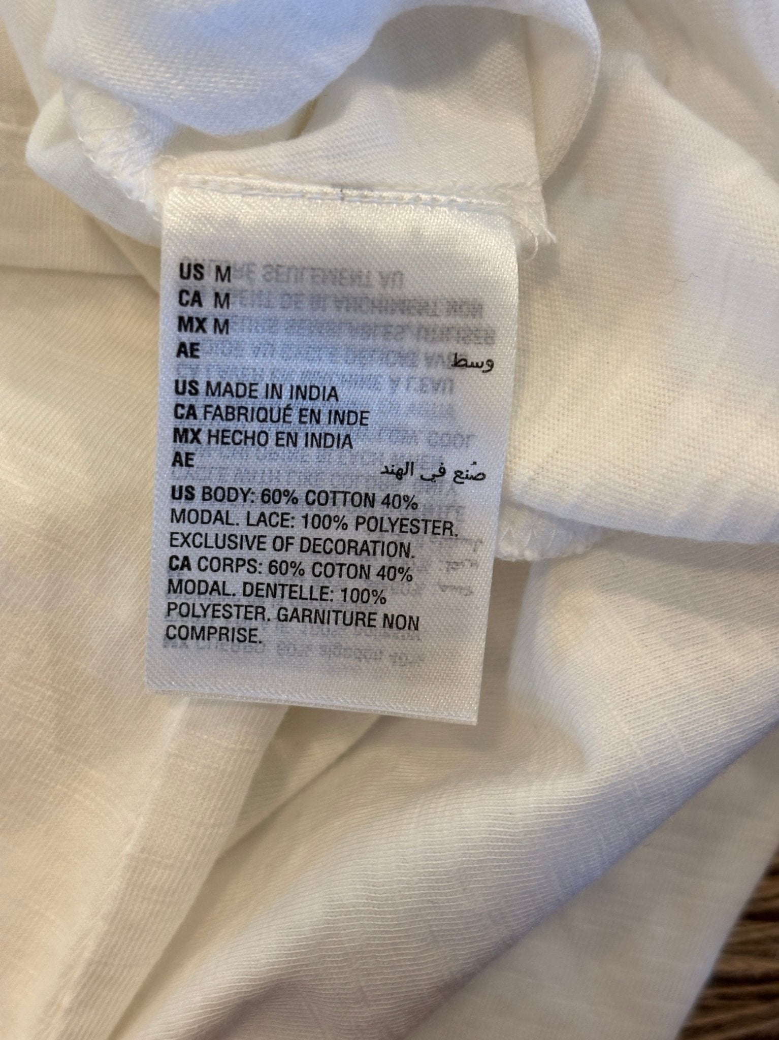 Care label showing 60% cotton 40% modal body fabric and 100% polyester lace Made in India
