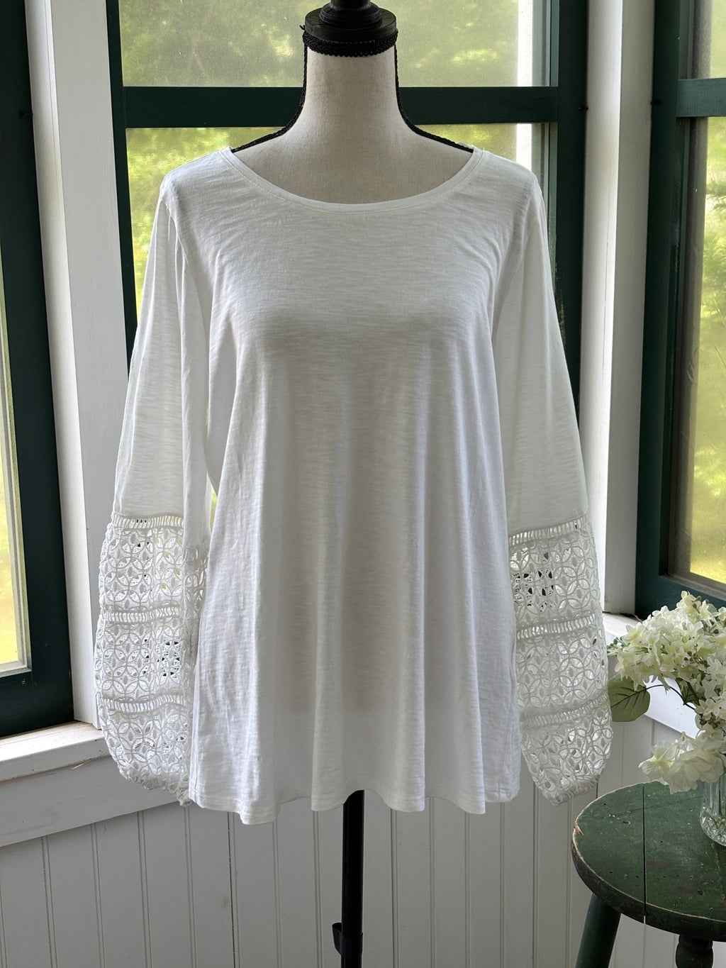 JM Collection white crochet lace bell sleeve top front view on mannequin showing full length and floral lace sleeves, size Medium NWT