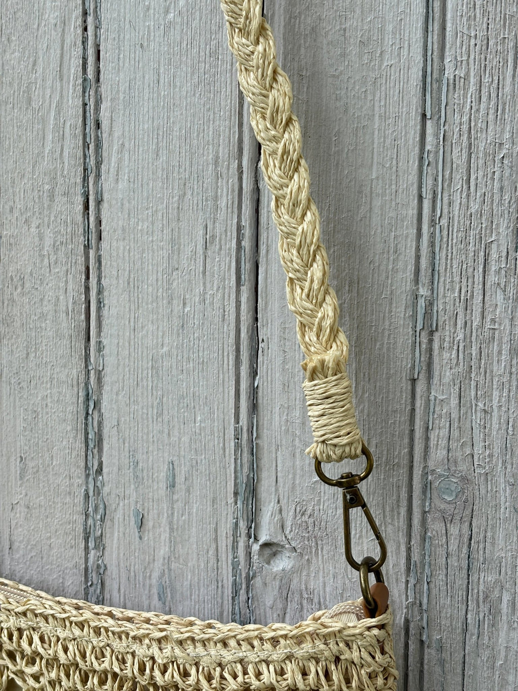 Close-up of braided natural strap with antique brass swivel clasp on Kaleidoscope crochet crossbody bag