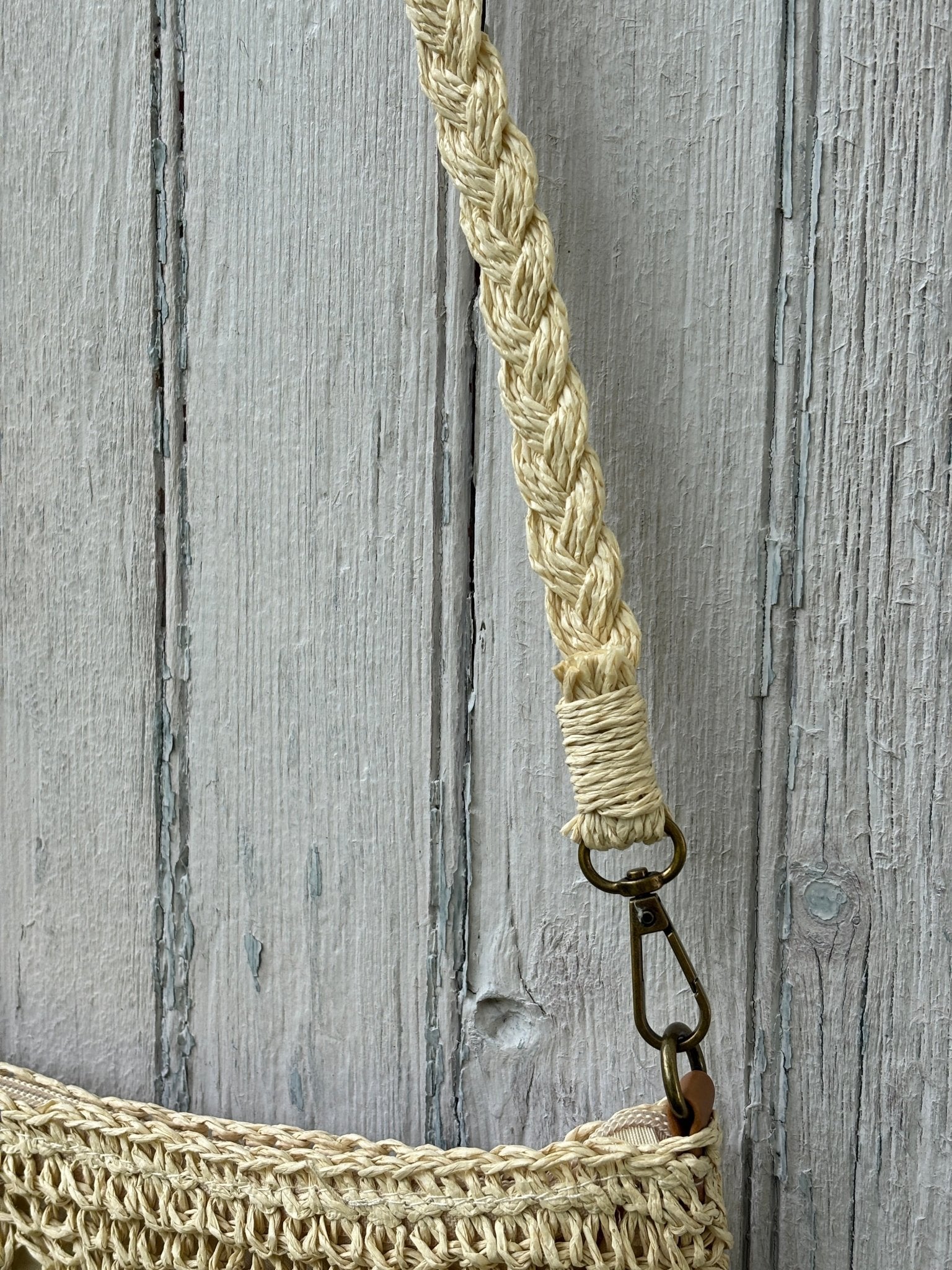 Close-up of braided natural strap with antique brass swivel clasp on Kaleidoscope crochet crossbody bag
