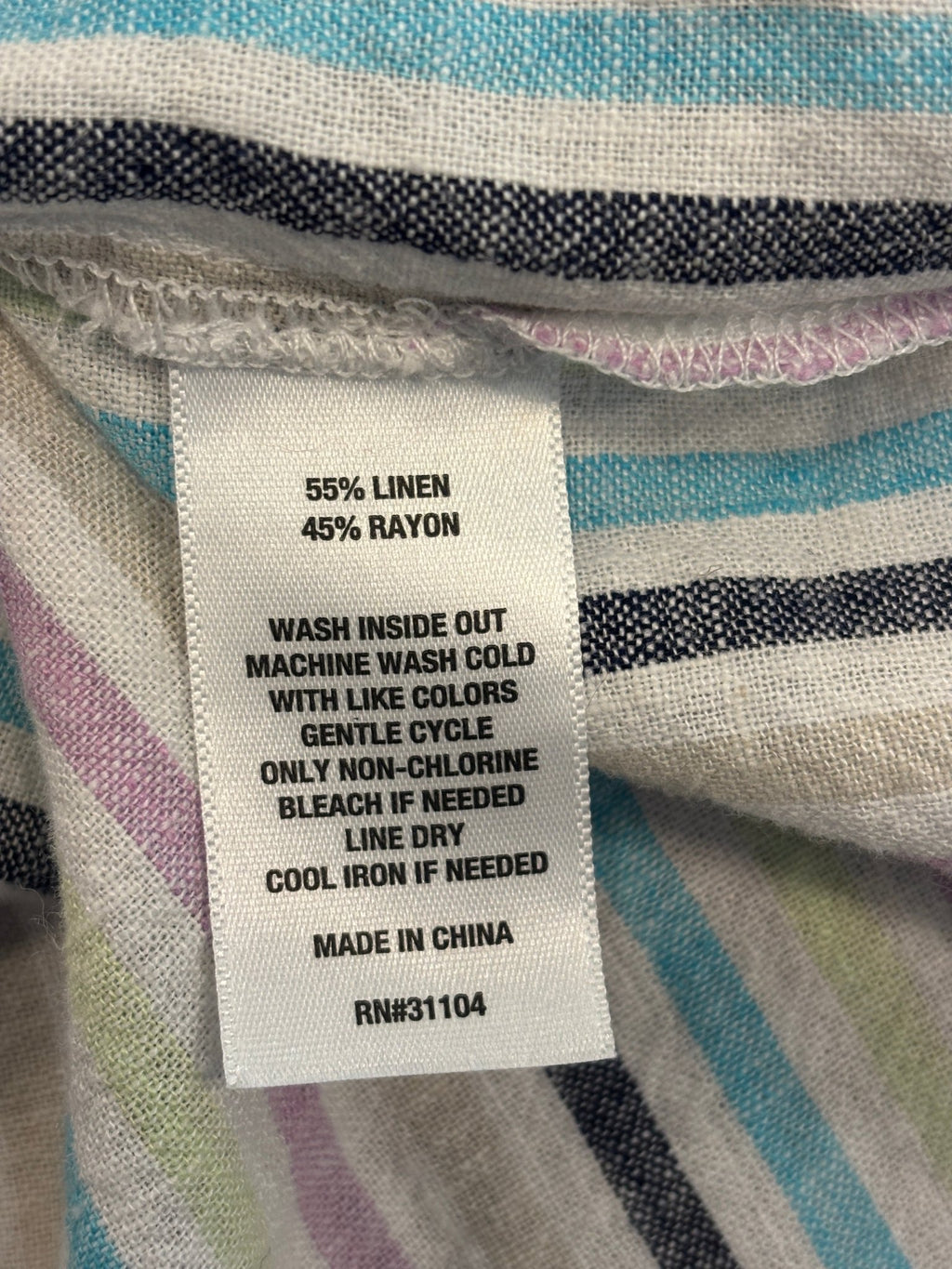 Interior care label showing 55% linen 45% rayon, machine wash cold gentle, line dry