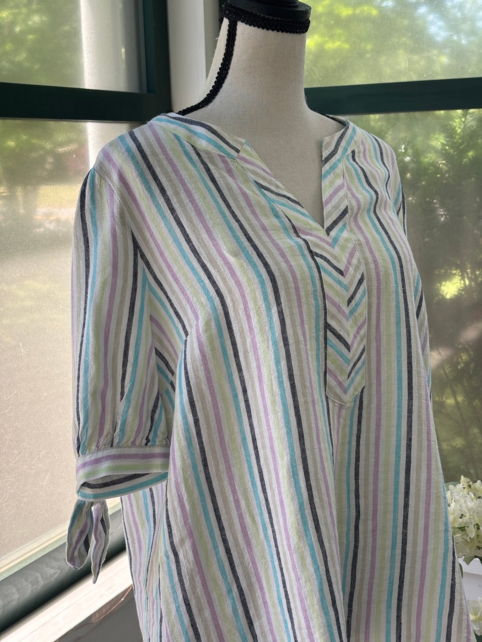 Close-up of neckline showing split V and stripe chevron pattern at center front