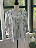 Front view of Kim Rogers multi-stripe linen tunic top on dress form, split V-neckline and 3/4 tie-knot cuff sleeves visible