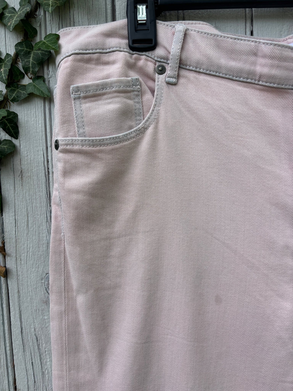 Close-up of front pocket and waistband detail on LOFT blush pink crop jeans