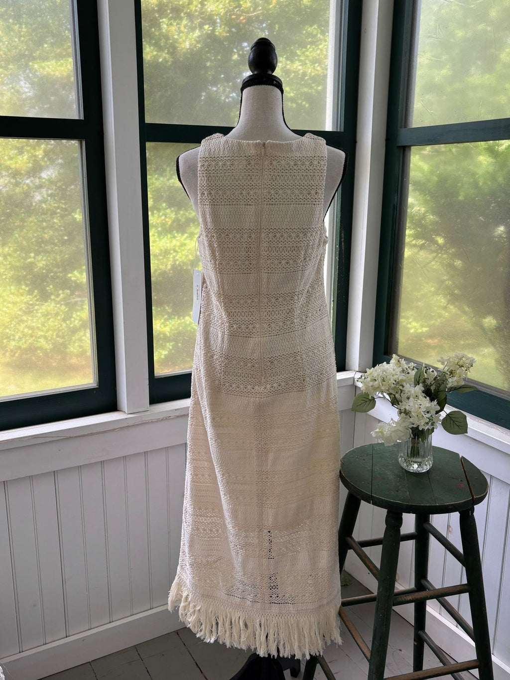 Detail shot showing fine open stitch and floral crochet panel on London Times ivory maxi dress bodice