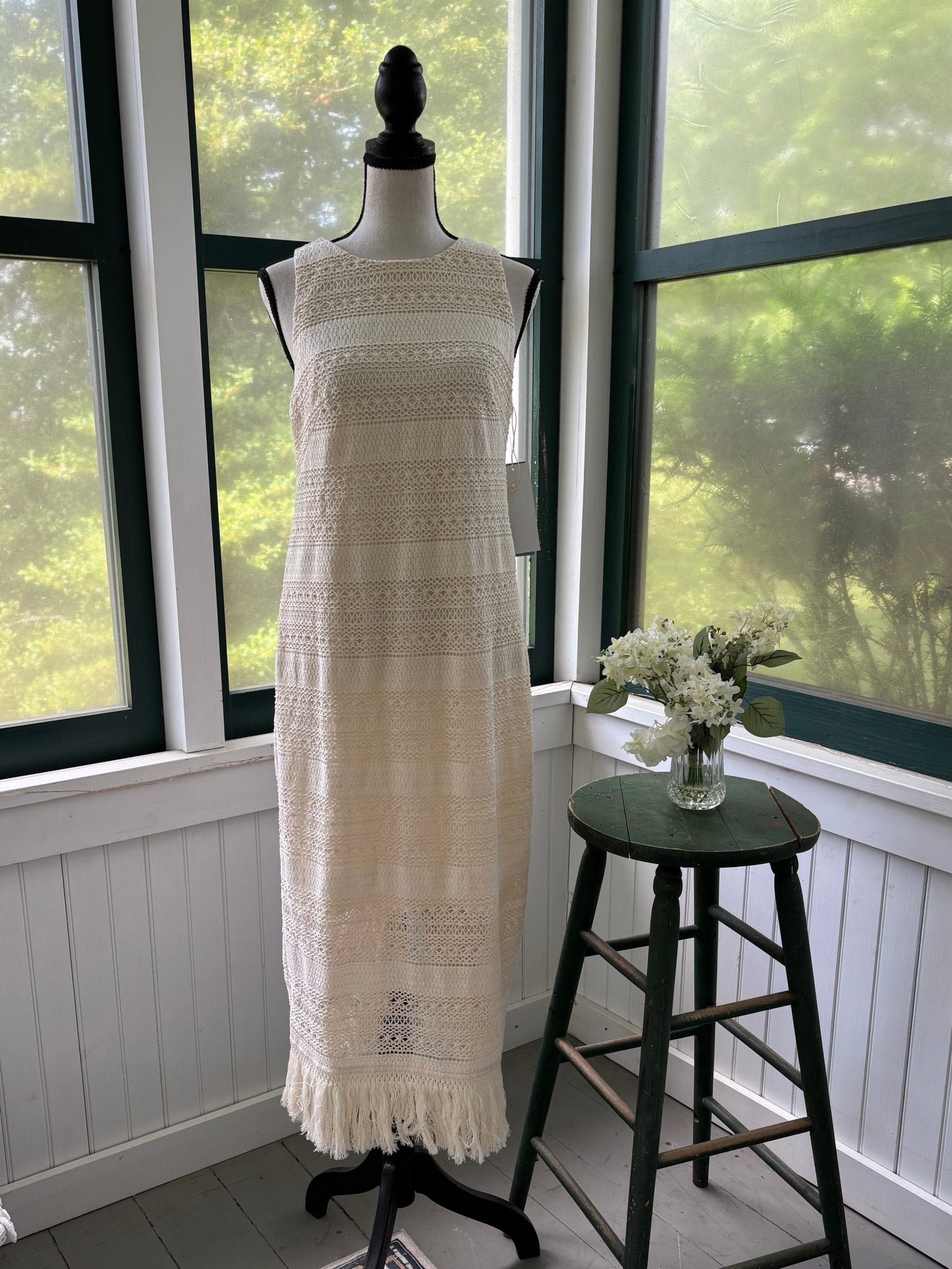 London Times natural ivory crochet open stitch maxi dress front view on mannequin showing full length column silhouette and fringe hem, size 10 NWT