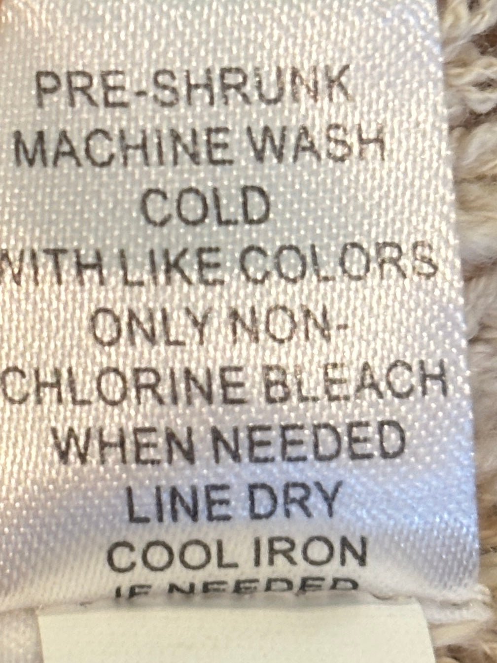 Care label for Lulu-B knit cardigan, machine wash cold, line dry