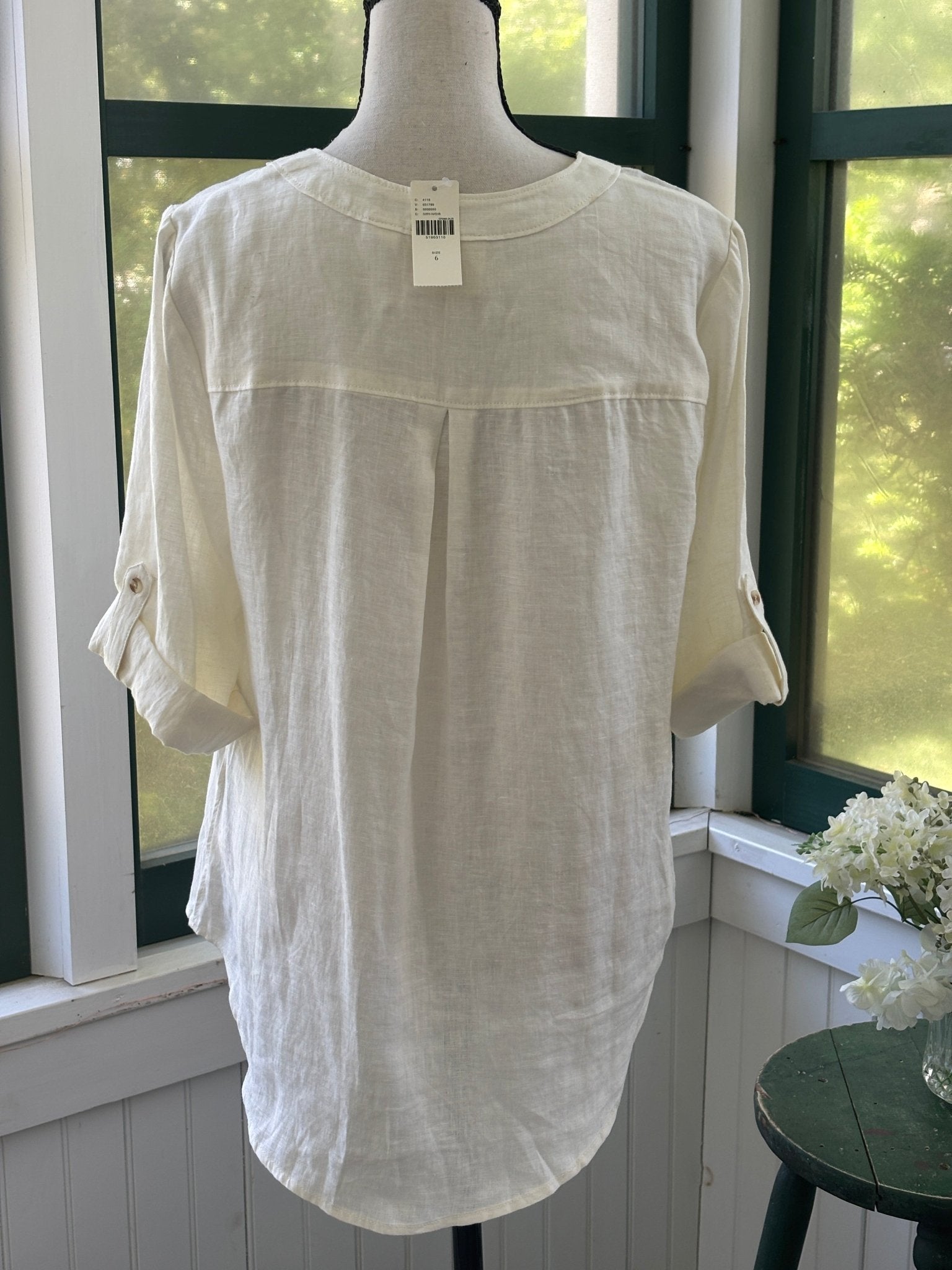 Back view of Maeve by Anthropologie ivory linen lace-up top showing center back pleat and roll-tab sleeve detail