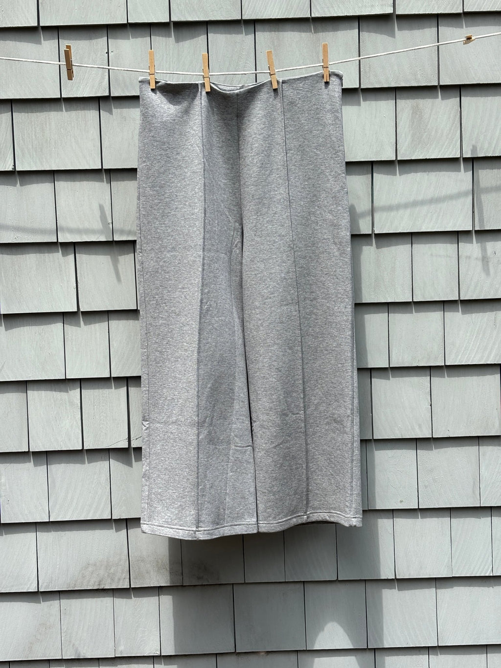 Mango MNG medium grey wide leg pants front view hanging showing full length and clean front seam detail, size Large NWT