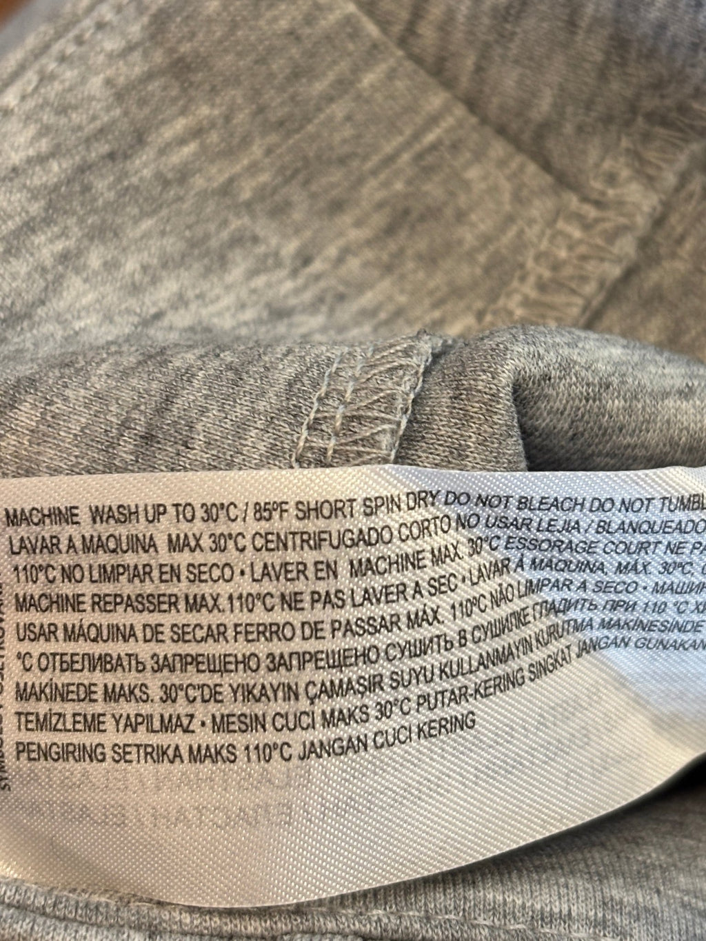 Care instructions label showing machine wash cold details on Mango wide leg pants