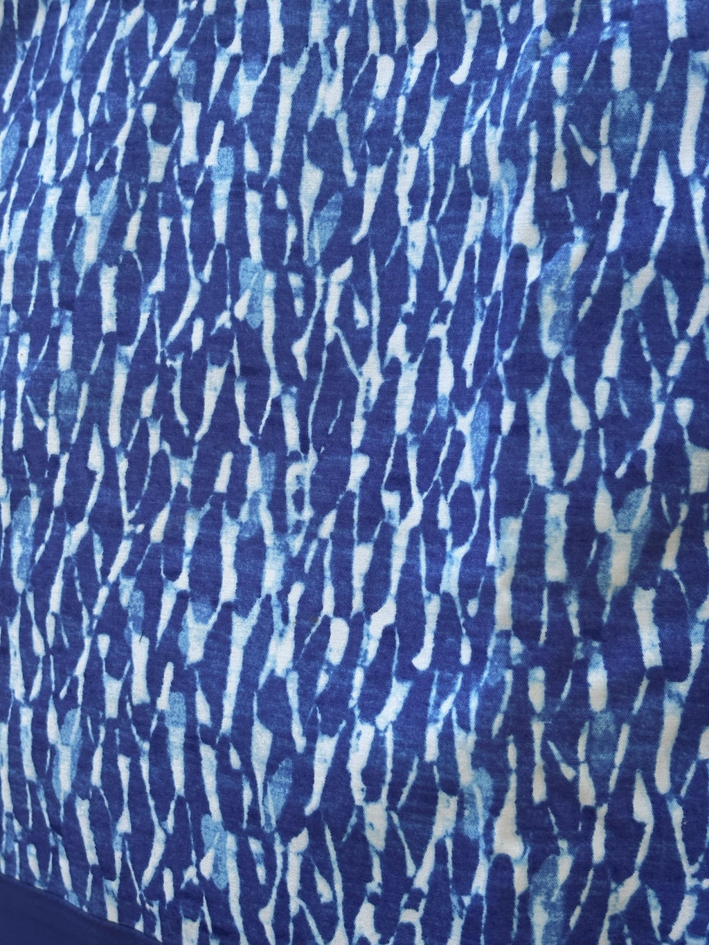 Close-up of watercolor brushstroke print on Michael Michael Kors blue mini skirt
