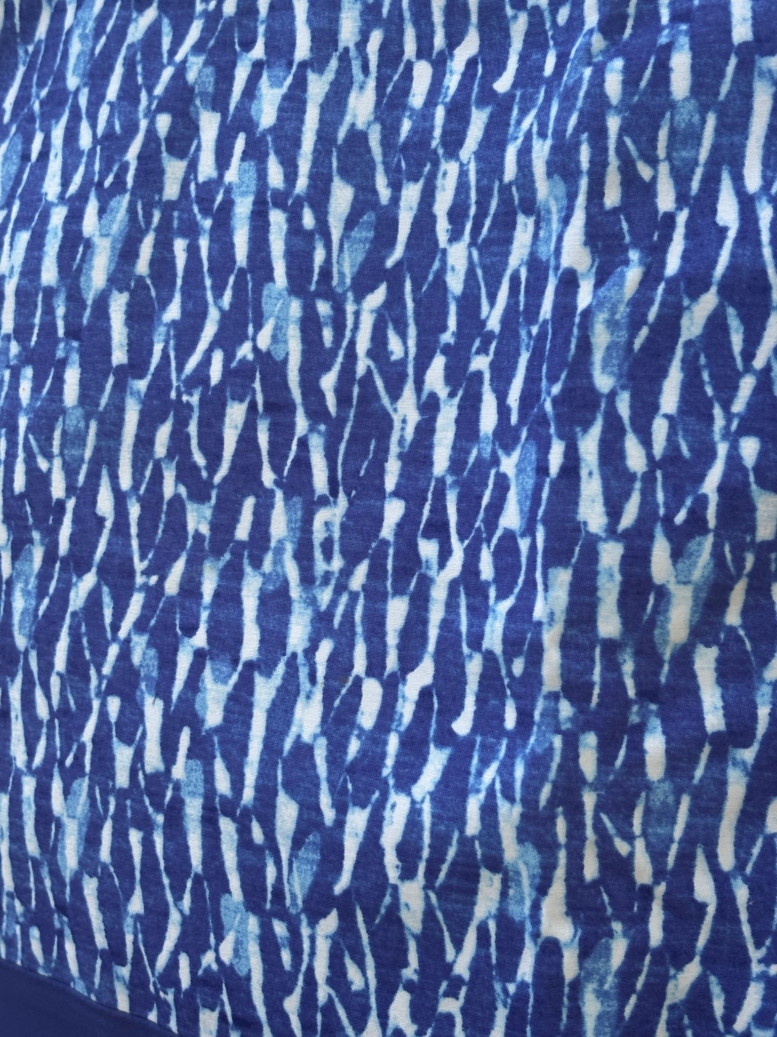 Close-up of watercolor brushstroke print on Michael Michael Kors blue mini skirt