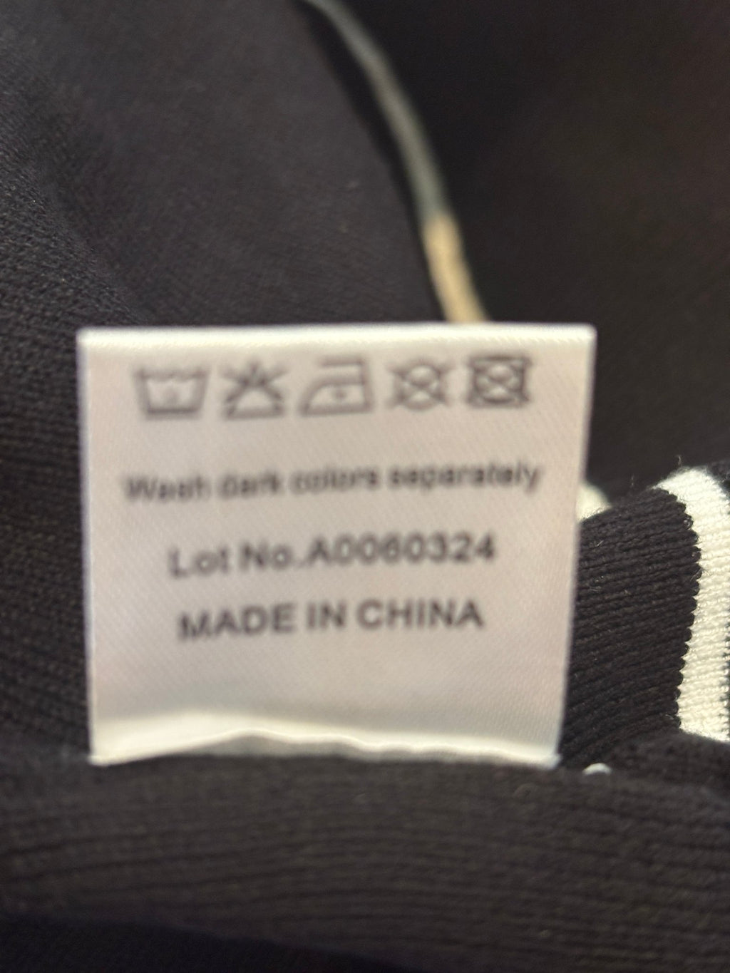 Care label showing wash dark colors separately, made in China