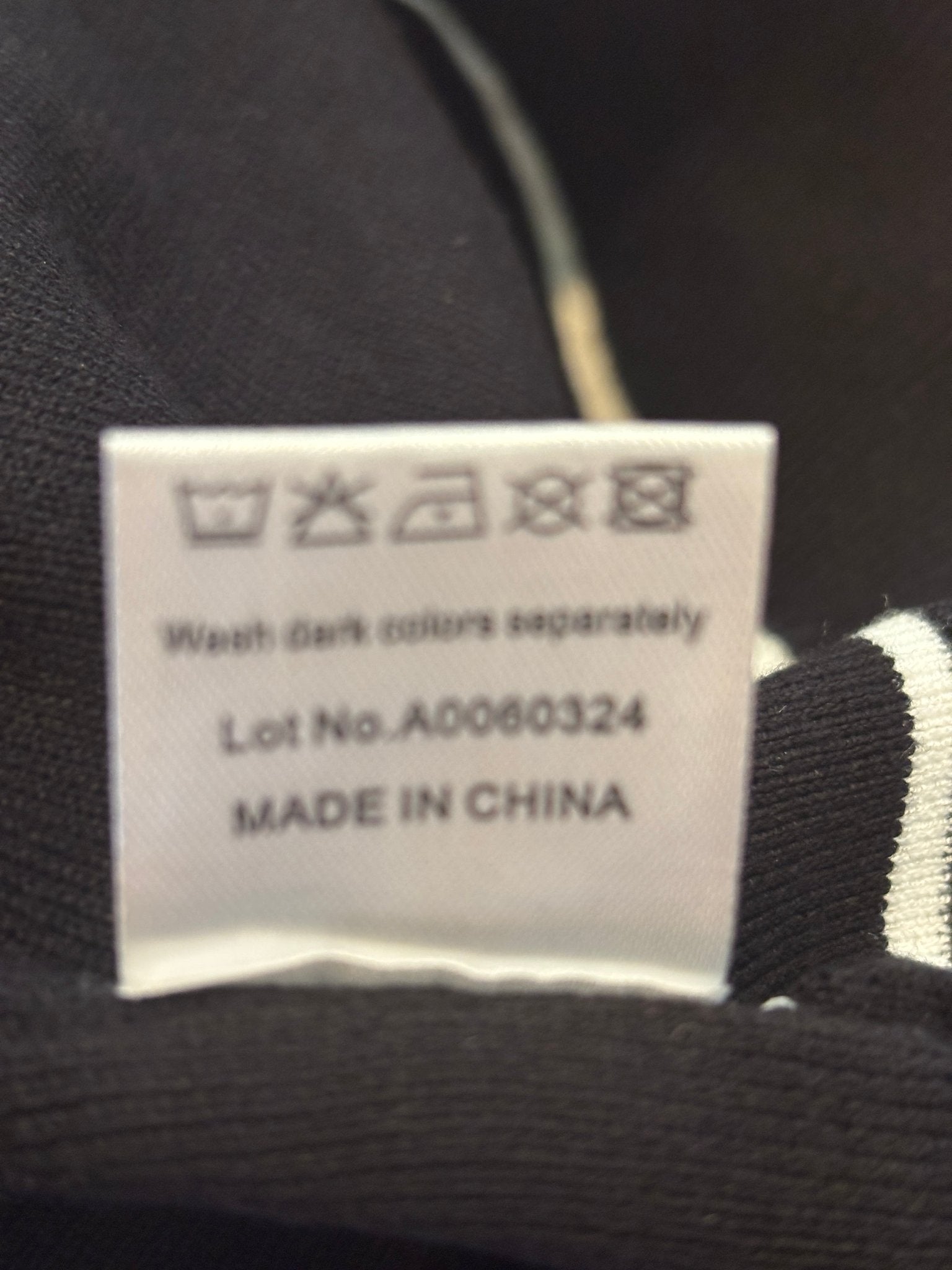 Care label showing wash dark colors separately, made in China