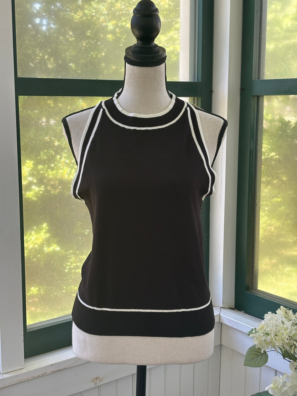 Miholl black knit tank top with white contrast trim at neckline and hem, size large, front view on mannequin