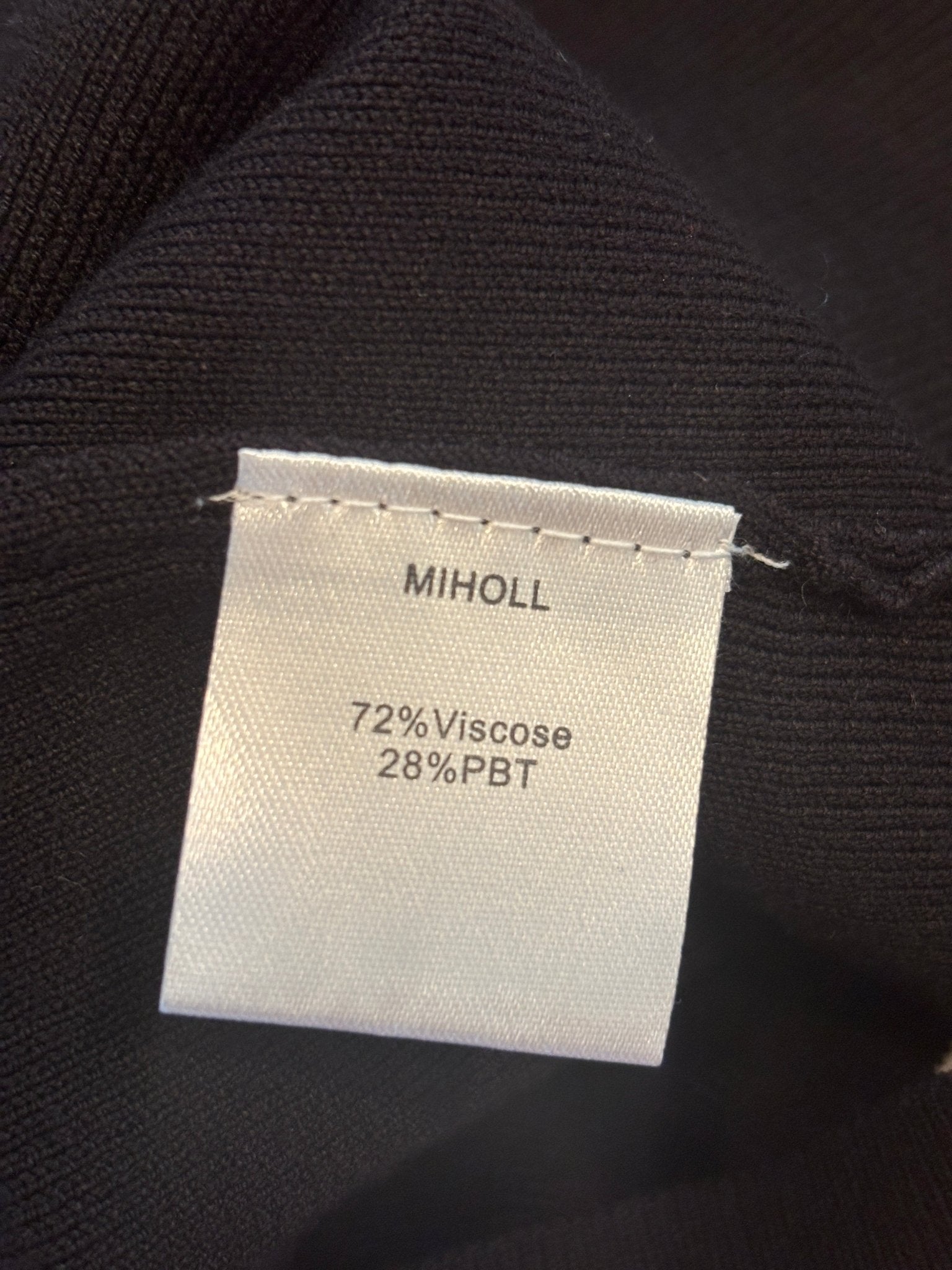 Fabric content label showing 72% viscose 28% PBT on Miholl black tank top