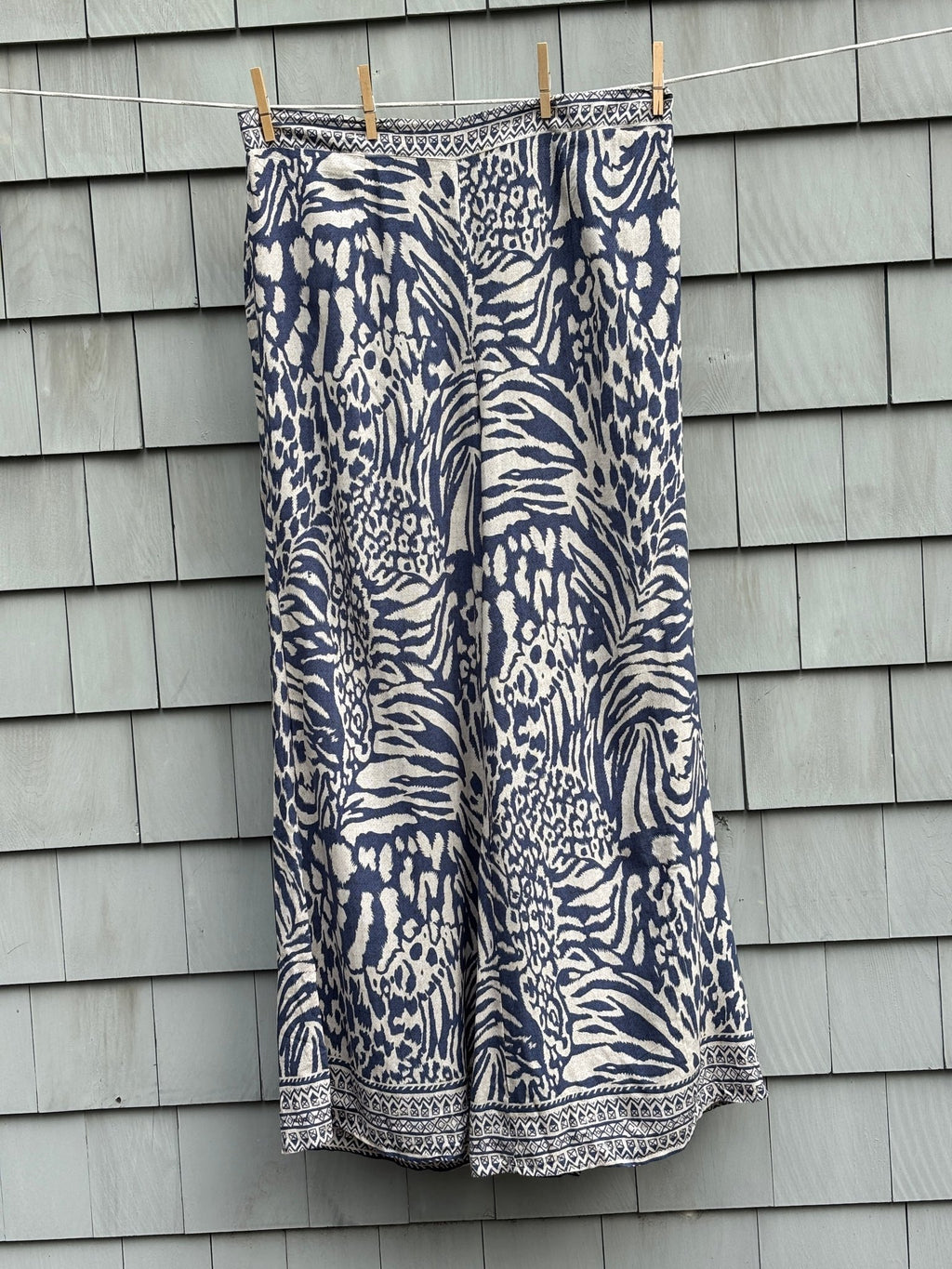Molly Bracken wide leg pants size XL navy cream animal print NWT front view clothesline