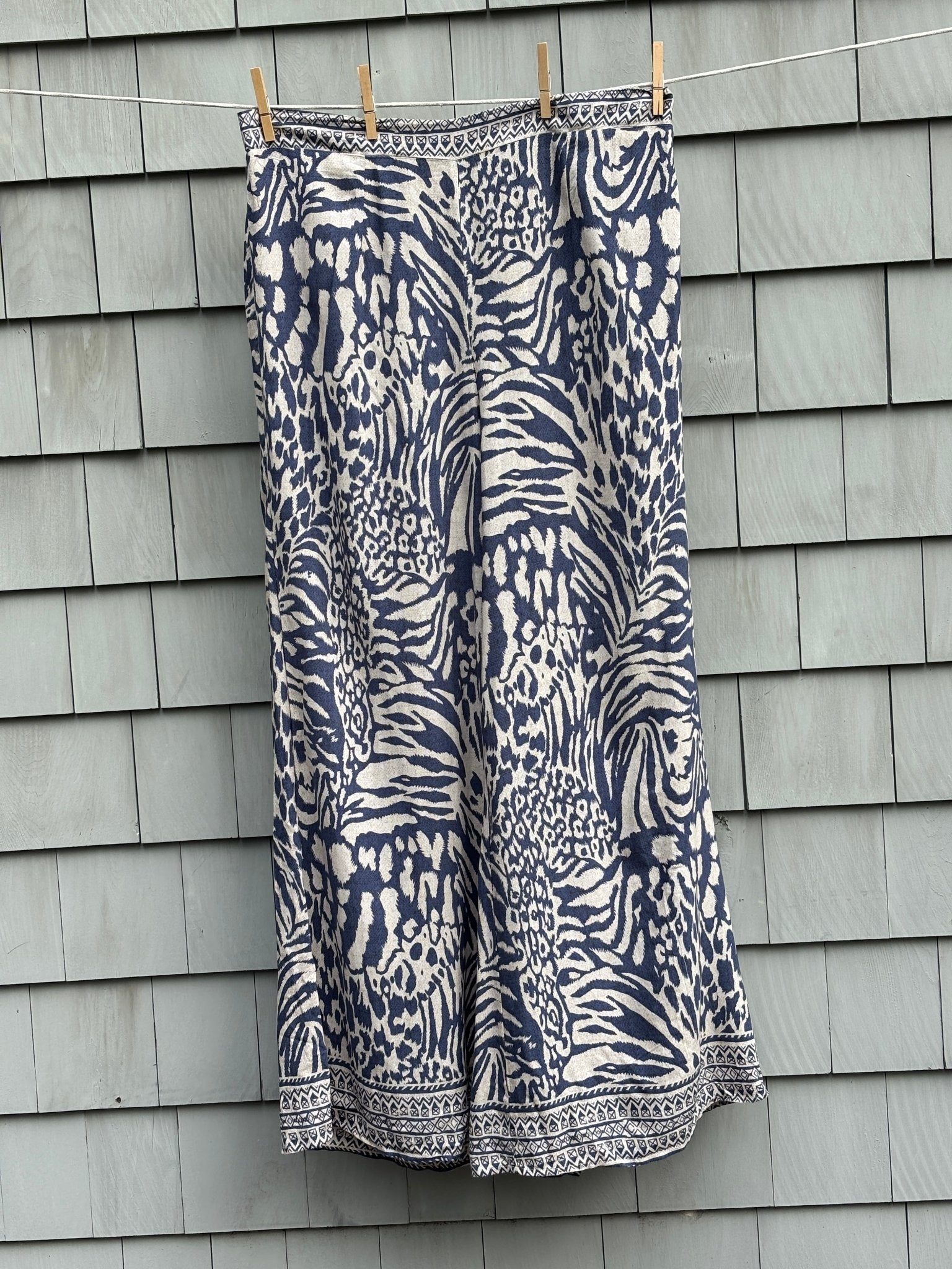 Molly Bracken wide leg pants size XL navy cream animal print NWT front view clothesline