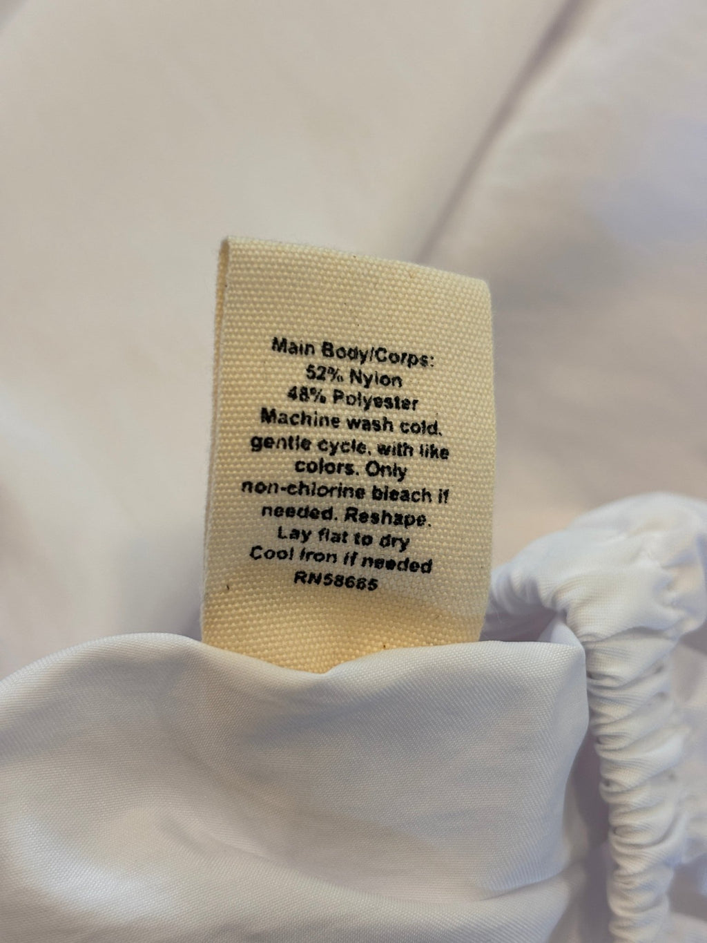 Care label showing fabric content for Open Edit white tiered maxi skirt