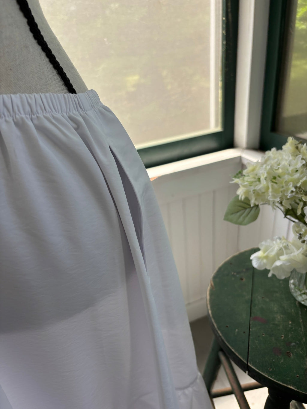 Close-up of side slit pocket on Open Edit white tiered maxi skirt