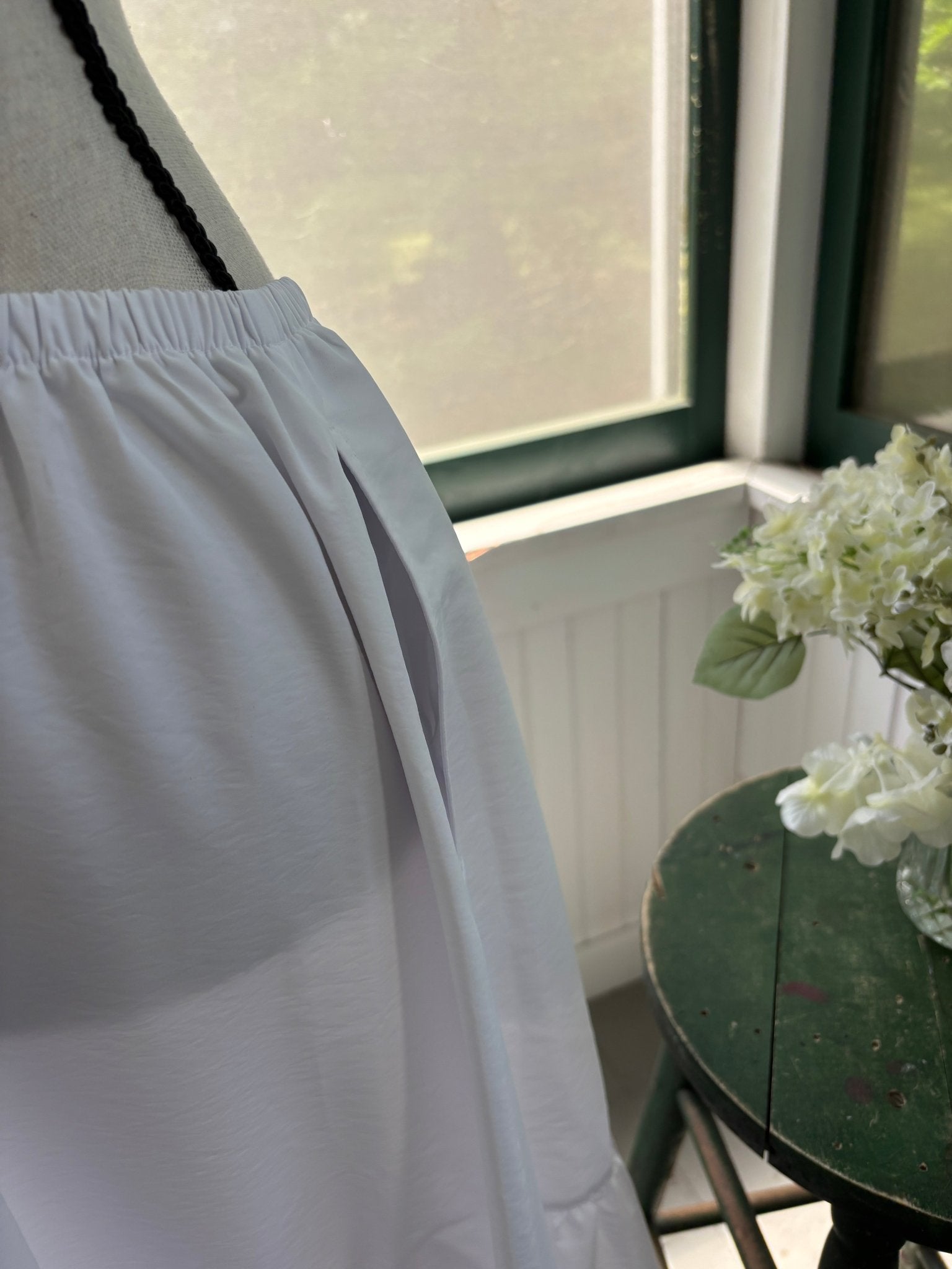 Close-up of side slit pocket on Open Edit white tiered maxi skirt
