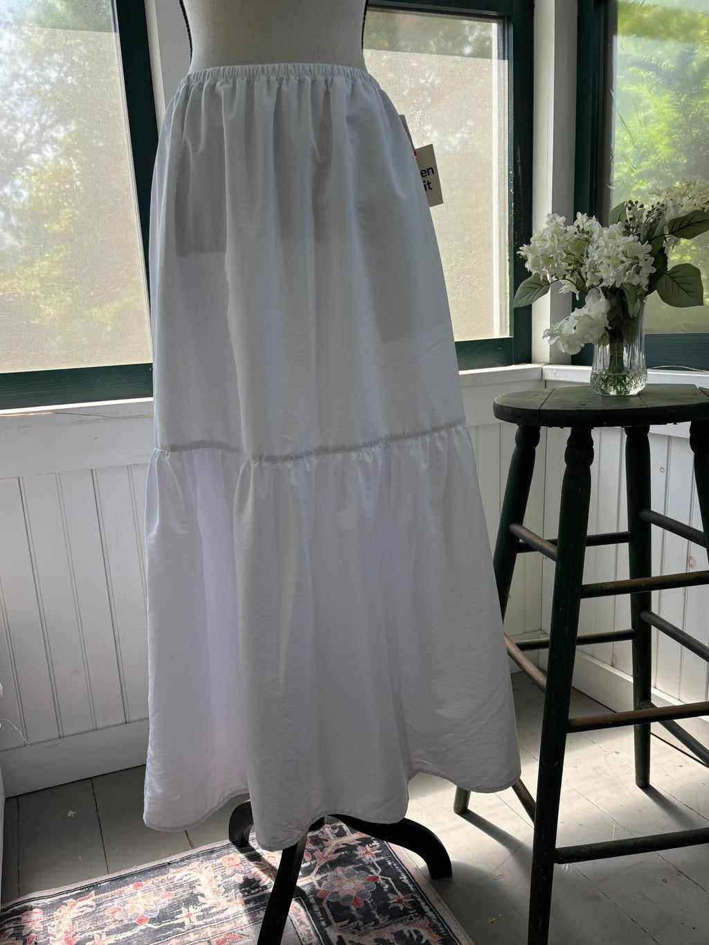 Open Edit white tiered maxi skirt with elastic waist, back view on mannequin