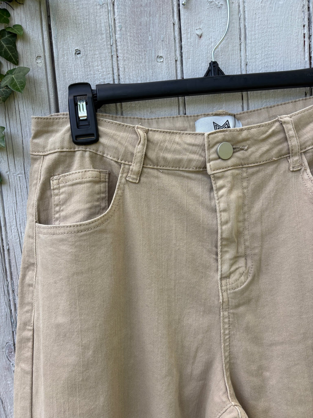 Close-up of front waistband and pocket detail on Paris Pop beige mom jean with silver button