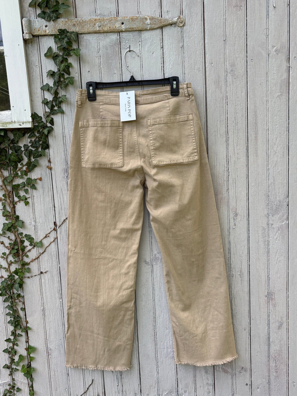 Back view of Paris Pop Mir Mom Jean showing large patch pockets and frayed hem with original hang tag