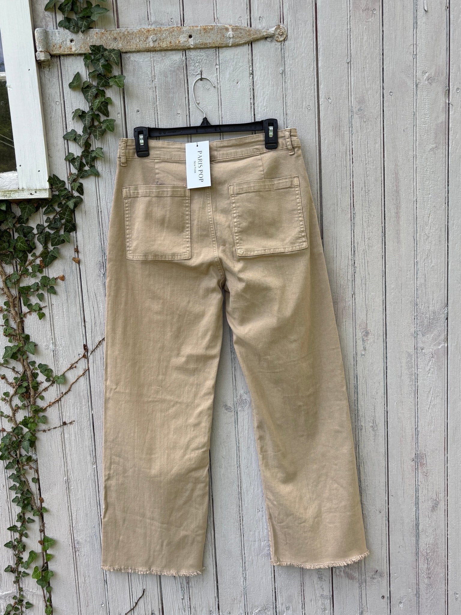 Back view of Paris Pop Mir Mom Jean showing large patch pockets and frayed hem with original hang tag