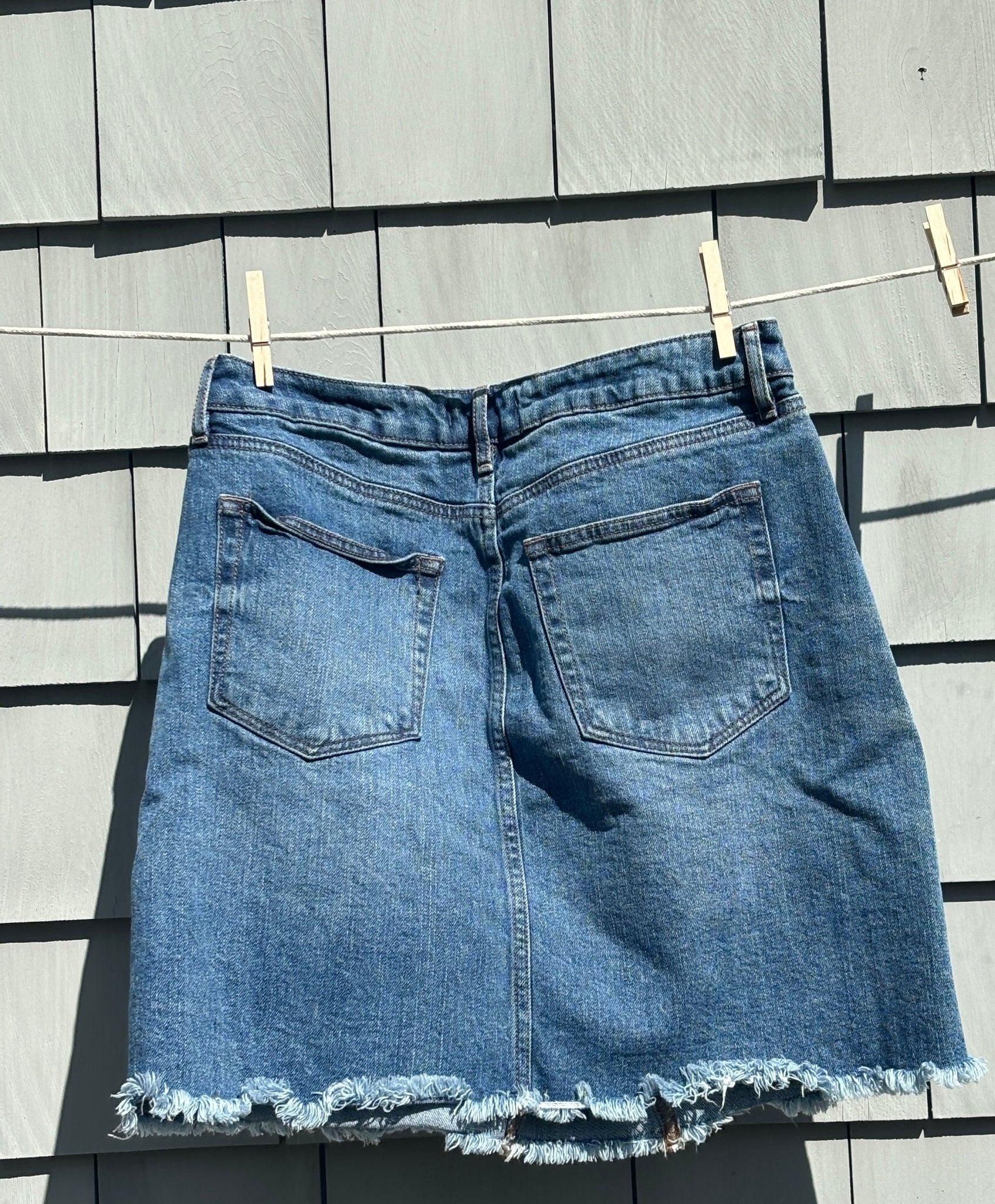 LOFT medium wash denim mini skirt back view back pockets frayed hem pre-loved skirts Sassy and Chic