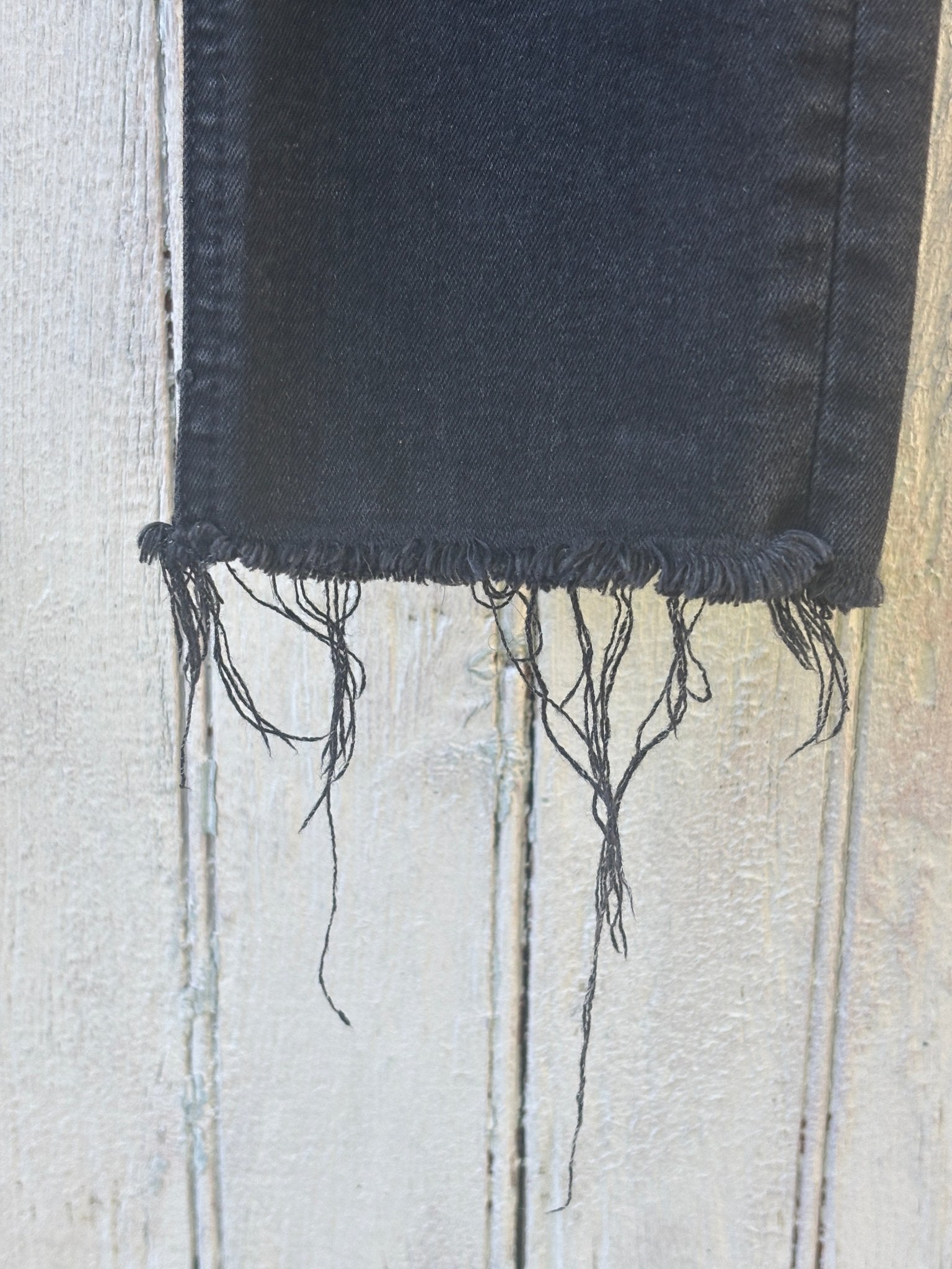 Rag and Bone ankle skinny jeans size 29 raw frayed hem detail close up washed black