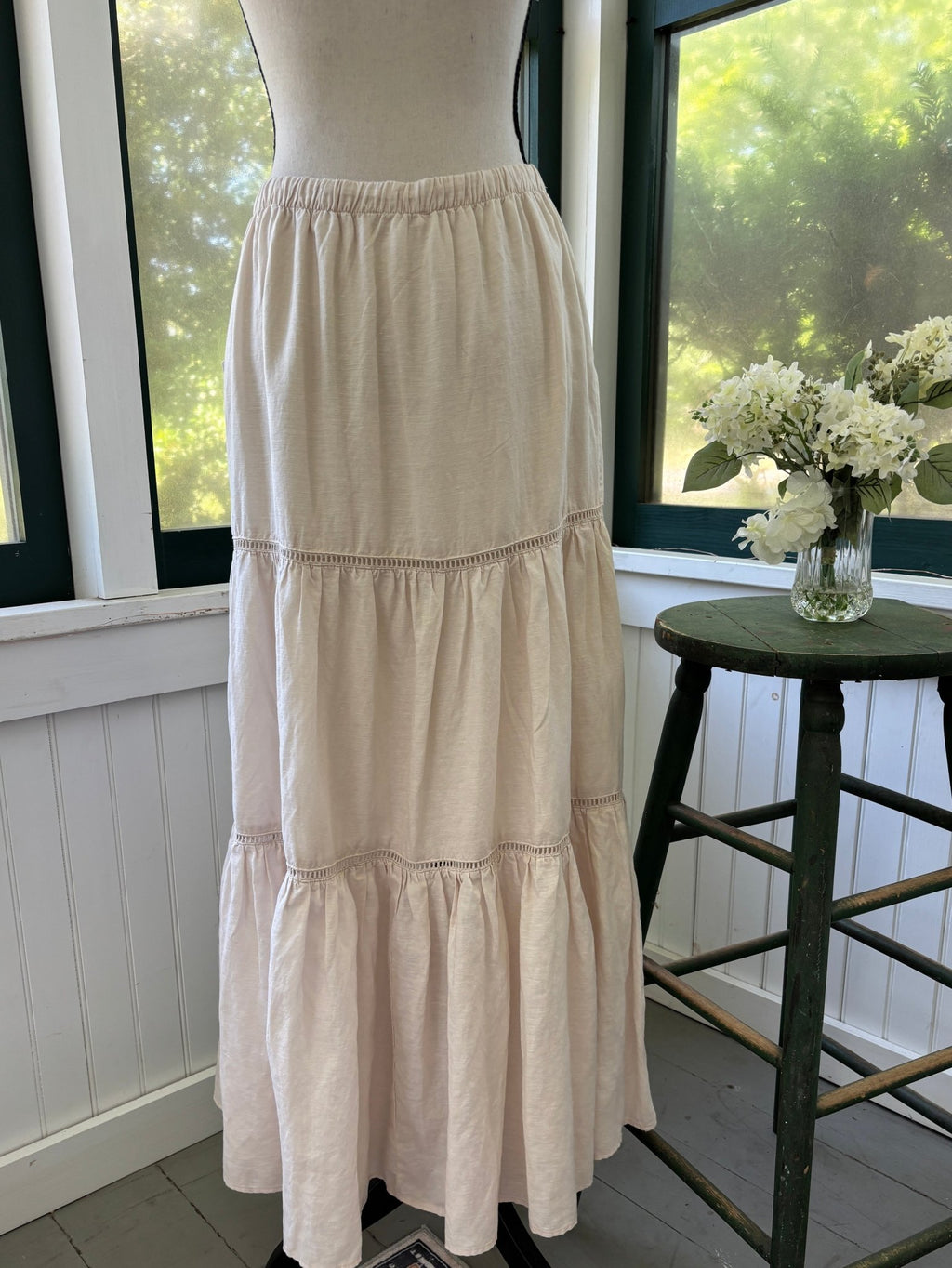 Full side view of Splendid Collection tiered linen maxi skirt on dress form showing three-tier silhouette
