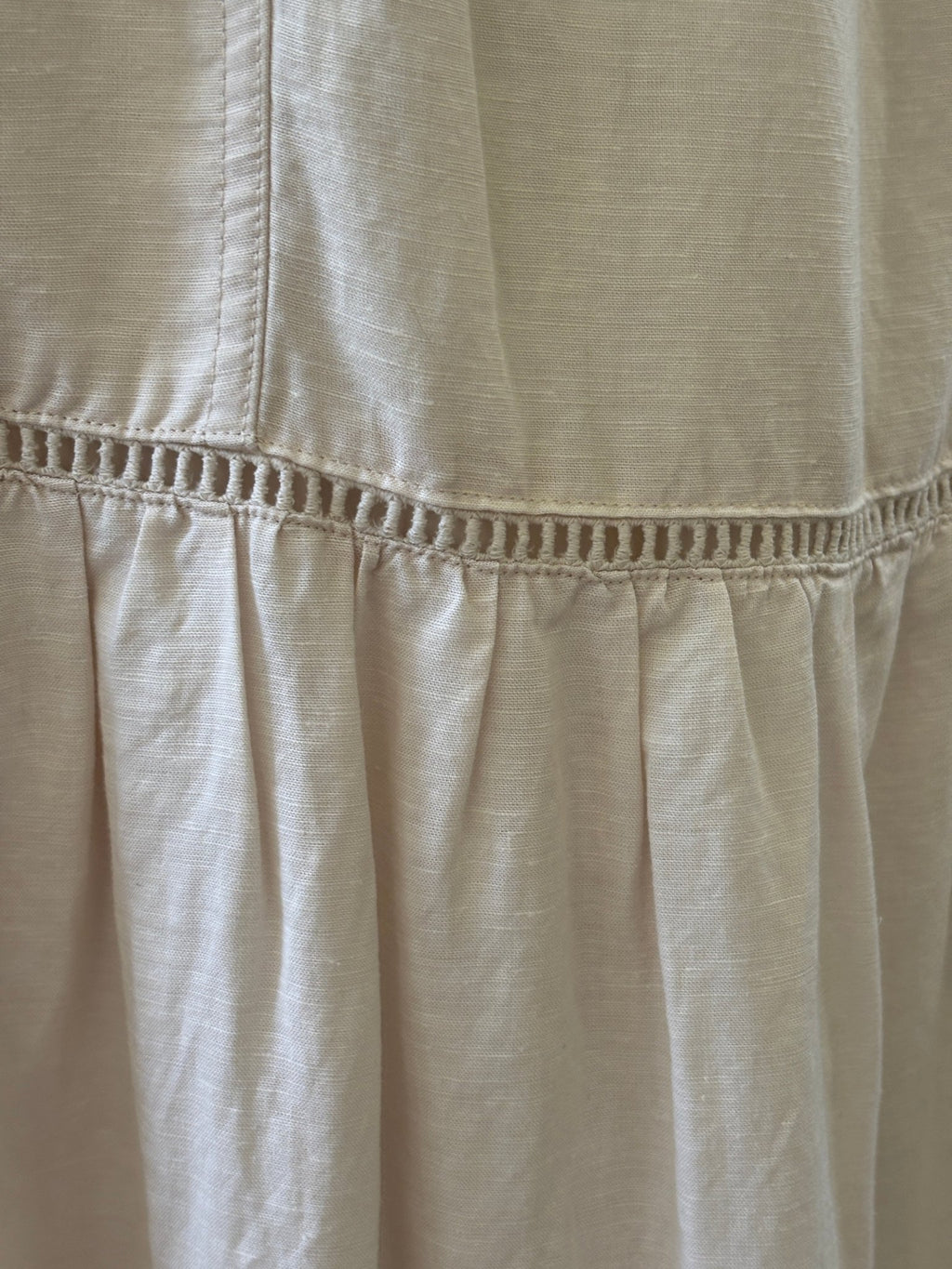 Detail of ladder-stitch trim at tier seam on Splendid Collection ecru maxi skirt