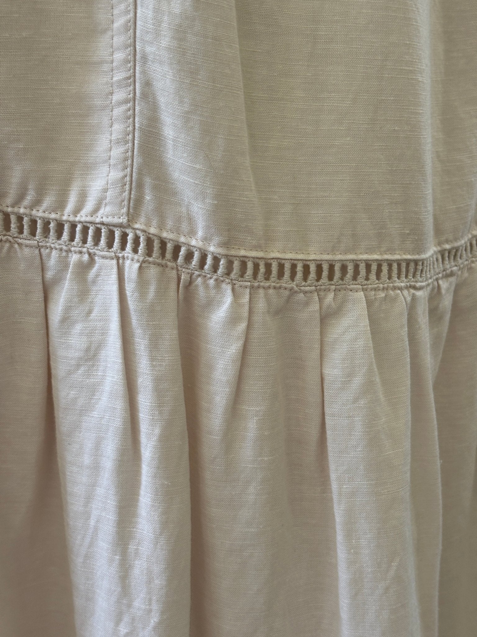 Detail of ladder-stitch trim at tier seam on Splendid Collection ecru maxi skirt