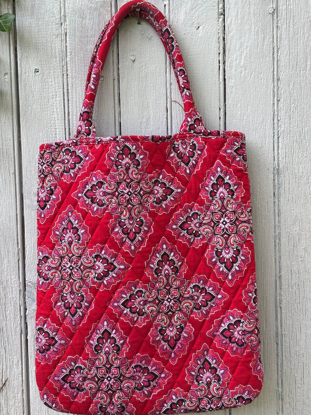 Back view of Vera Bradley red medallion quilted tote bag showing clean quilted cotton construction and padded handles