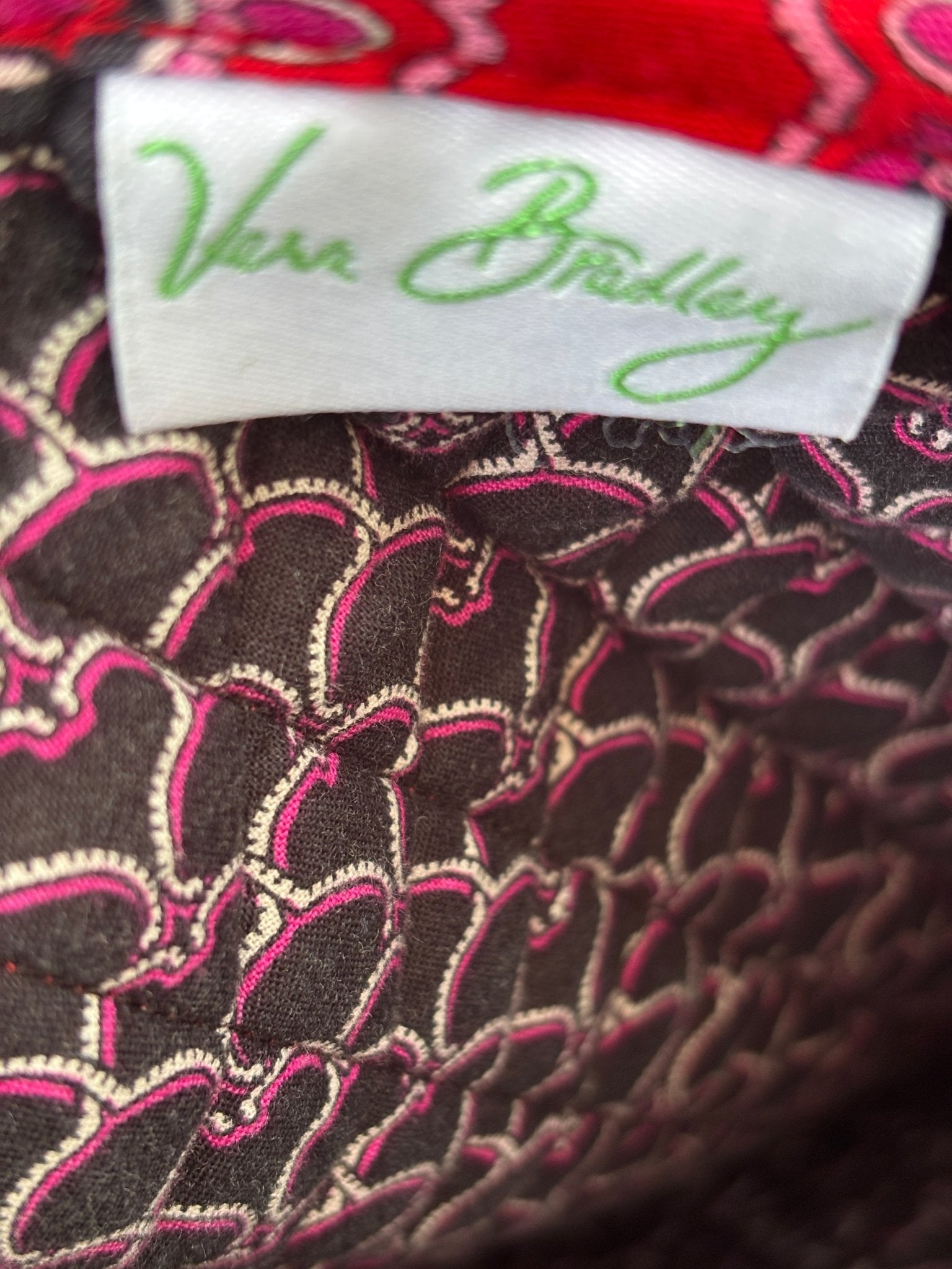 Vera Bradley brand label inside coordinating floral print interior of red medallion quilted tote bag