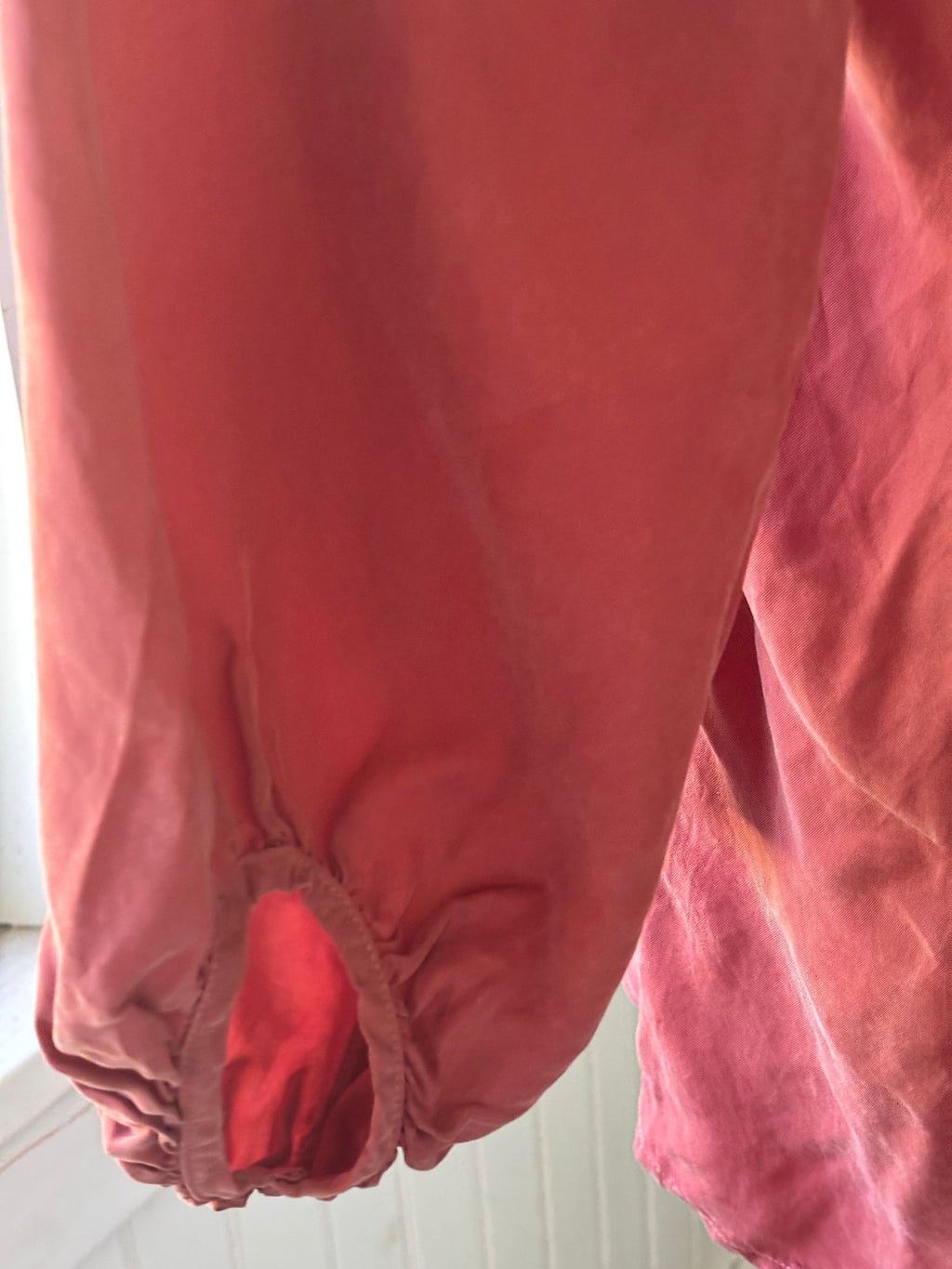 Close-up of gathered cuff on Young Fabulous & Broke dusty rose bishop sleeve blouse showing artisan color variation