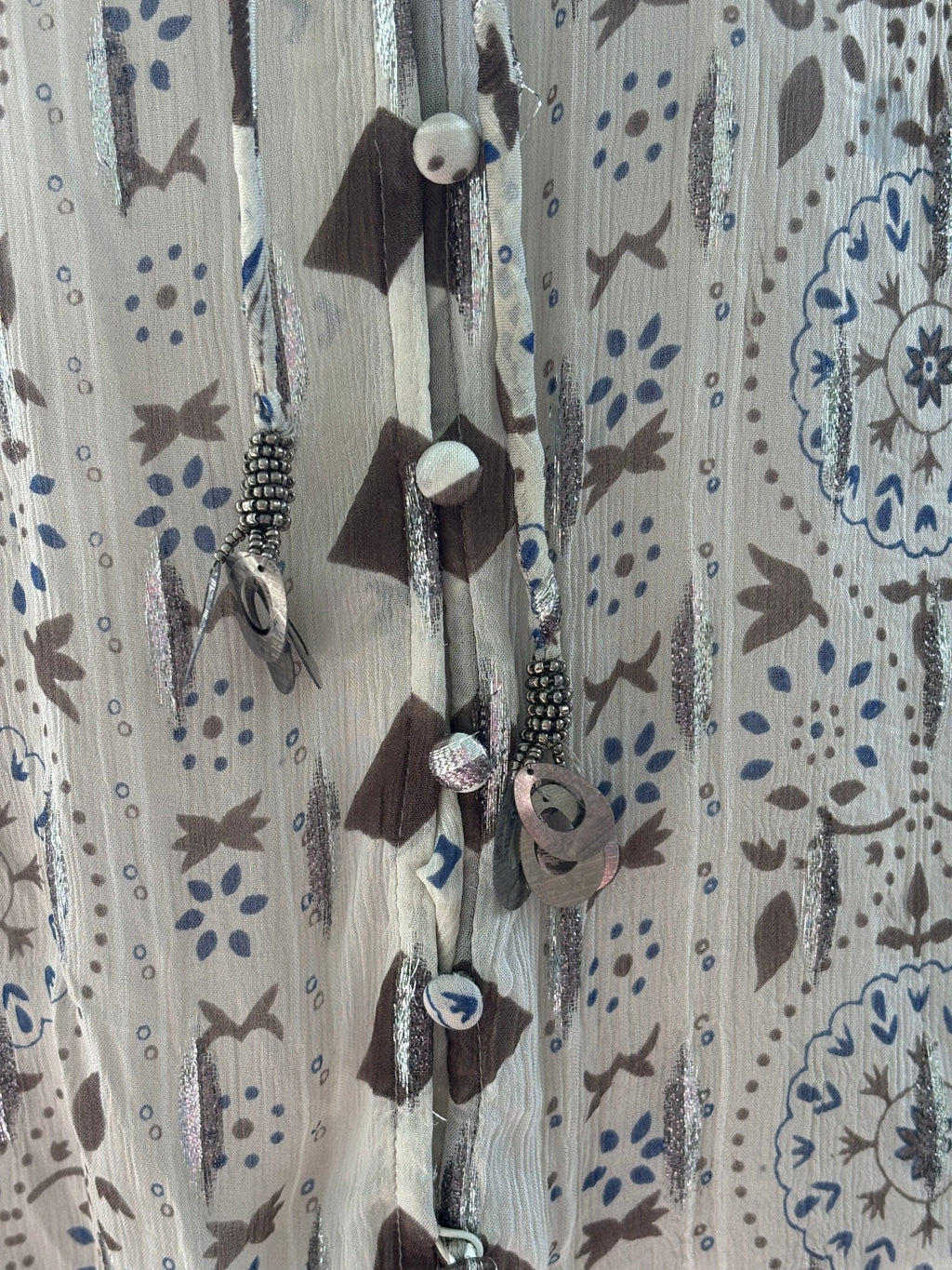 Close-up of beaded tassel tie detail and metallic stripe on Zara ivory boho blouse
